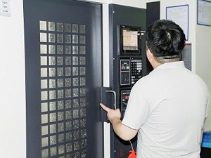 GripSeal employees start the machine